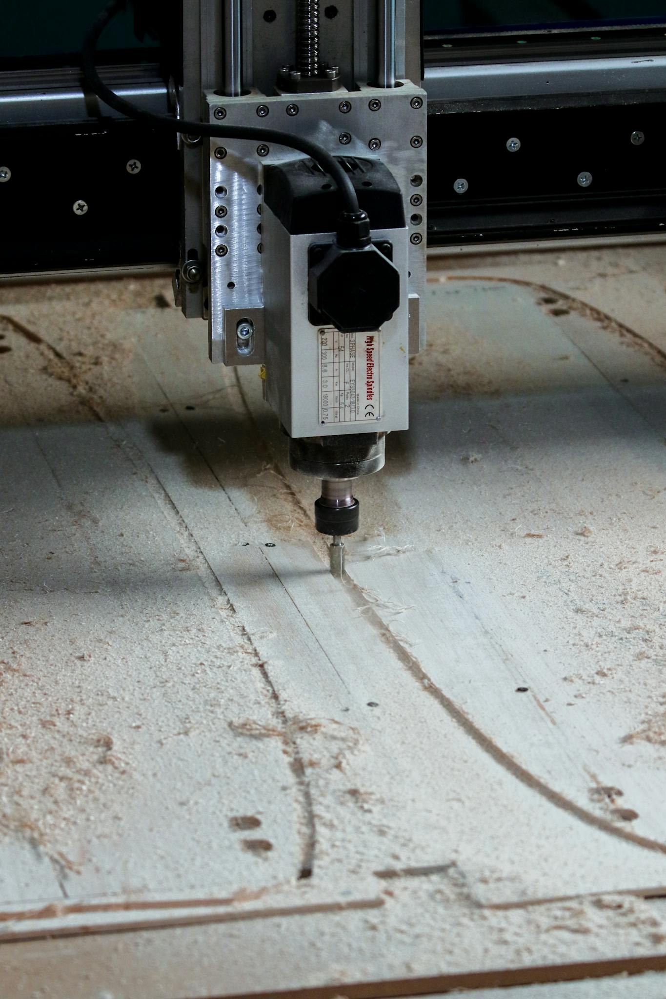 Close-up of a CNC machine in operation, showcasing precision cutting in a workshop setting.