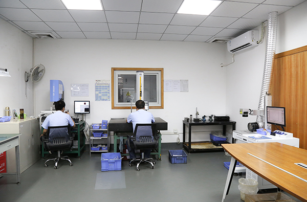HLW engineer inspecting CNC machined kitchenware accessories